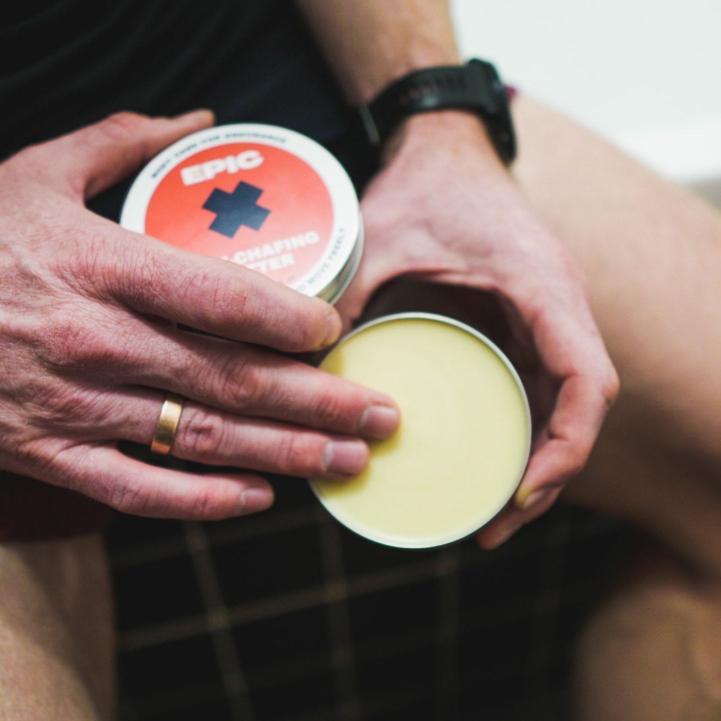 Runner applying anti-chafing butter to inner thighs